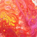 An abstract acrylic painting depicting swirls of yellow, pink, and red.