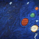 Chalk Pastel drawing of a solar system in outer-space on black paper. Space is colored a deep-blue with three white stars in a line on the top of the page. Solar system start in top right corner with an orange and yellow corner of the sun. On a diagonal from the top right corner to the bottom center of the page are planets. The planets designs and colors in that order are orange, yellow, green, red with three orange horizontal lines, a white planet with a ring and a blue planet with a ring.