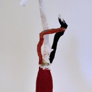 Mixed media bottle sculpture wrapped in fabric. Base is painted dark-red and has a long-thin white neck with a curved head. Two curved arms stick straight-up- one is pained red and one is painted black.