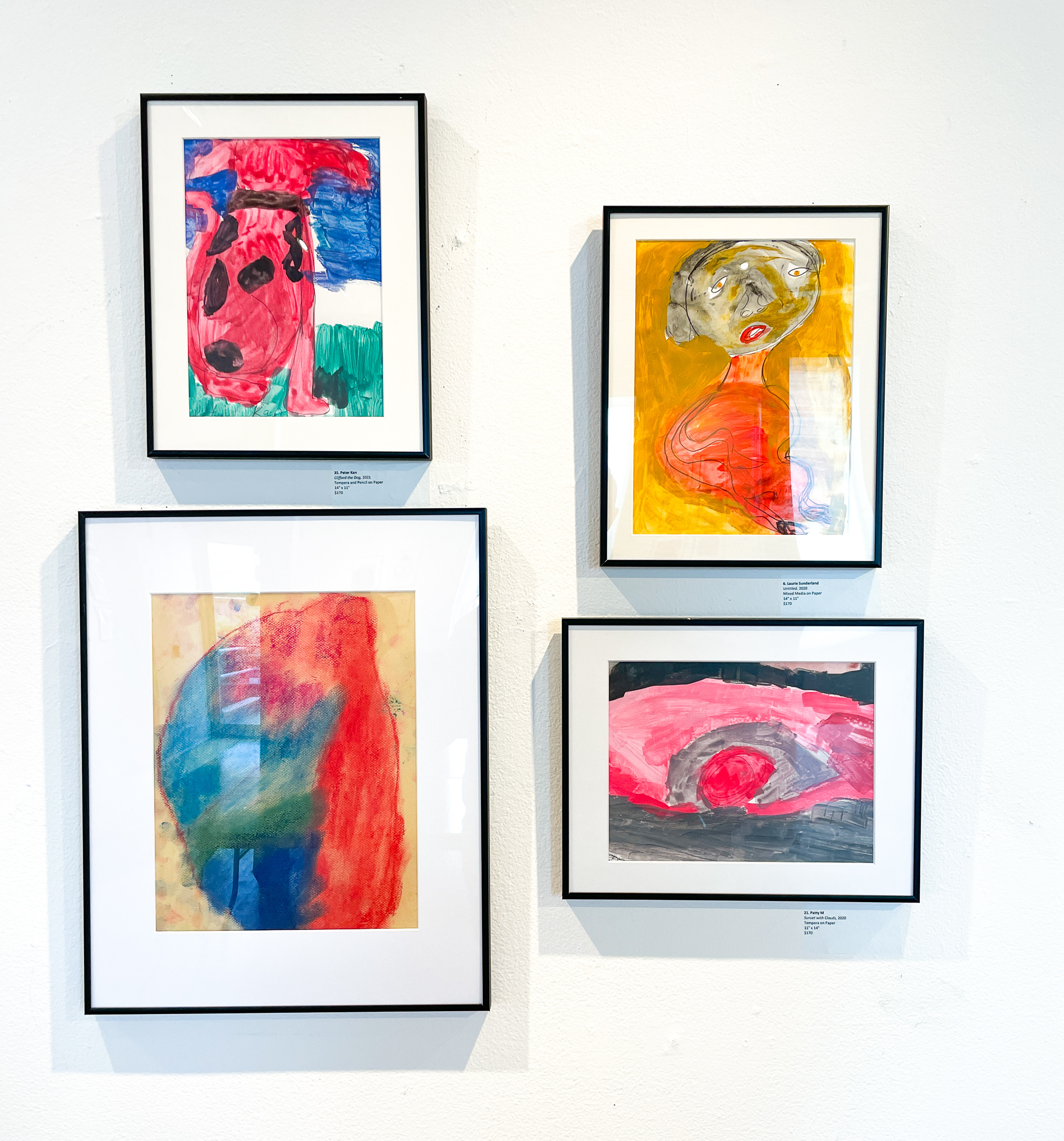 Gallery wall with four paintings, a red dog, a portrait of a woman, and two abstract paintings