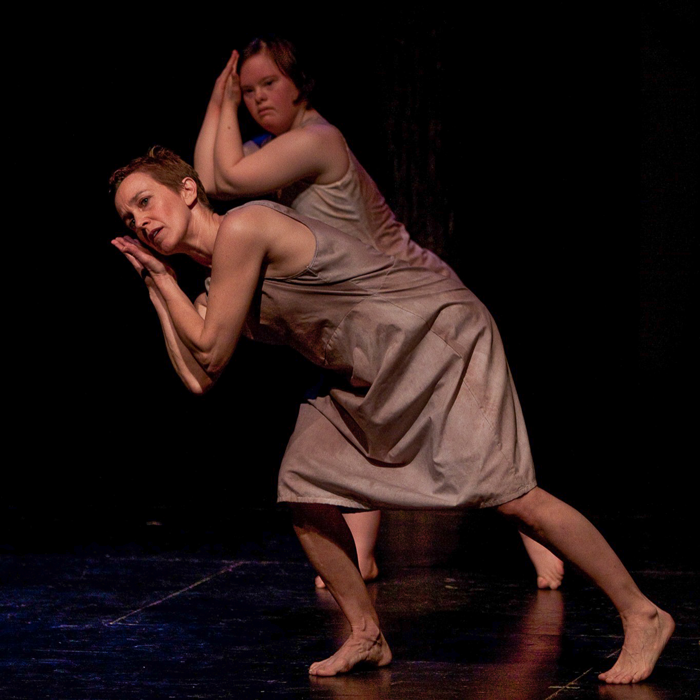 Dawn Lane and two CATA dancers pose with their hands by their heads in grey dresses
