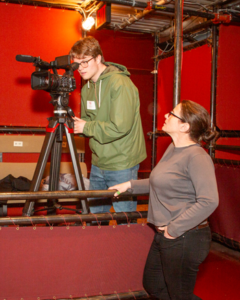 CATA artist Max looks through a camera at Shakespeare & Company