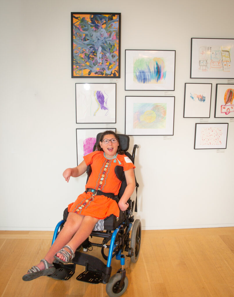 CATA artist Grace Boucher poses with her painting in CATA's Annual Art Show at the Clark Art Institute (photo by David Dashiell)