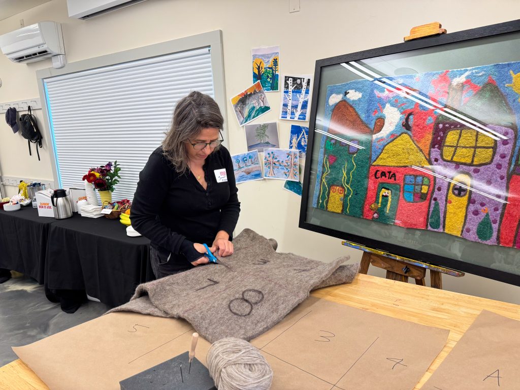 Janet makes cuts to create individual felting panels.