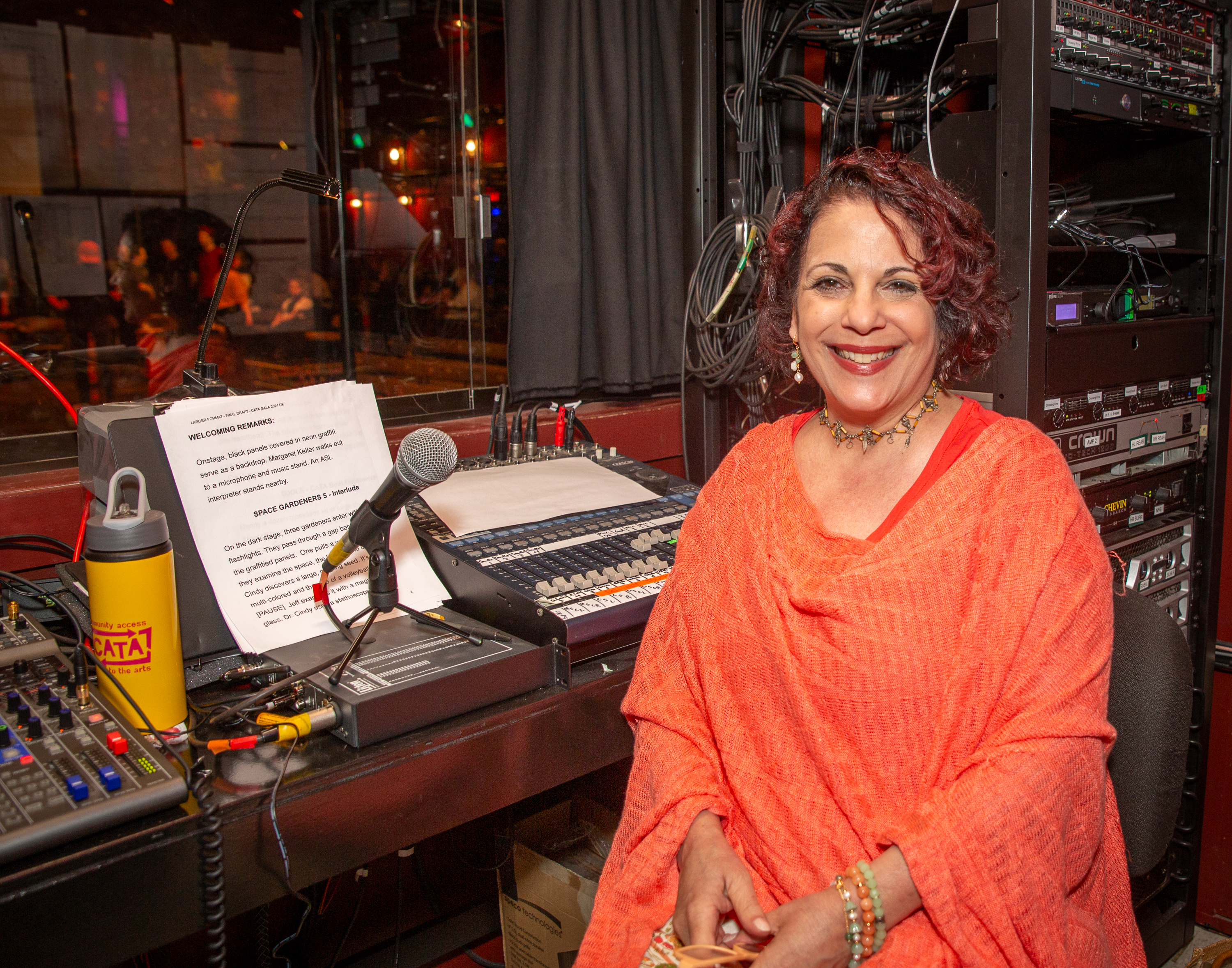 Paula Boyajian (CATA Faculty) provides live audio description from the sound booth. Audience members can request free headphones to listen.