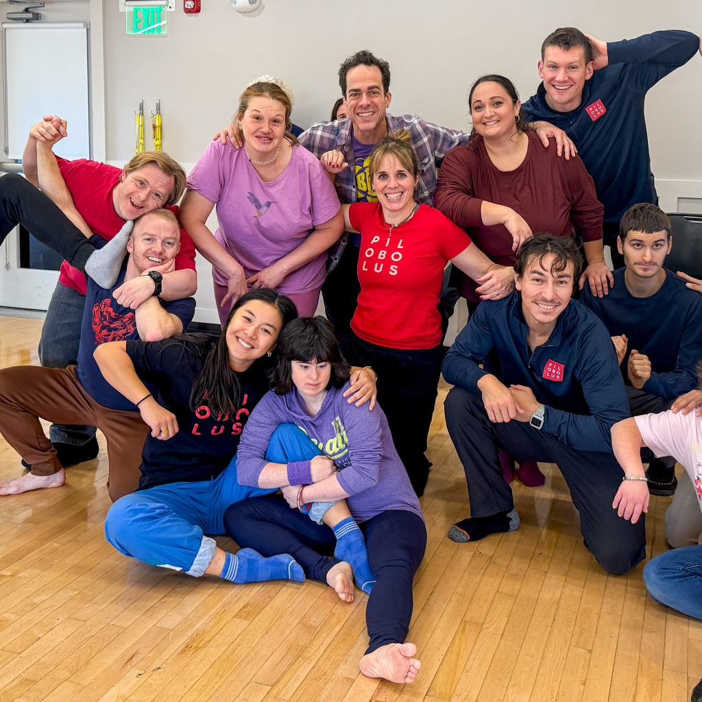 A group of dancers in an interconnected pose.