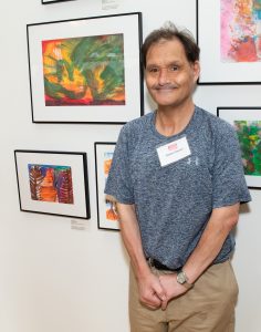 CATA artist Robert Sartori stands near his artwork at the Clark.