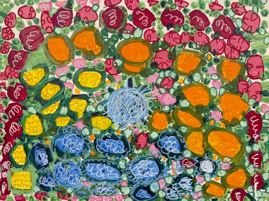 A dense garden scene with flowers of many colors sprouting between shades of green.