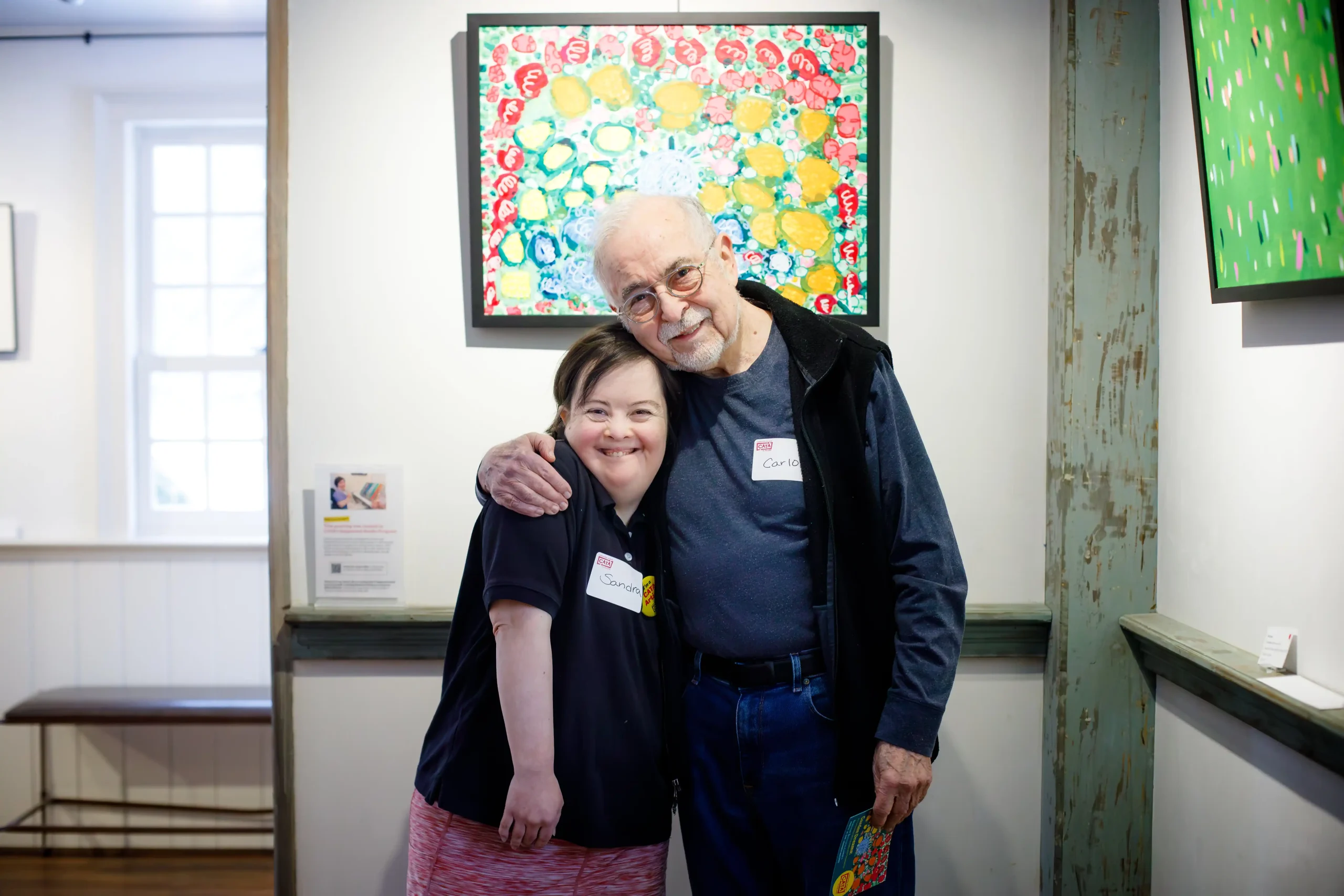 CATA artist Sandra and her father in front of her painting, "Pink."