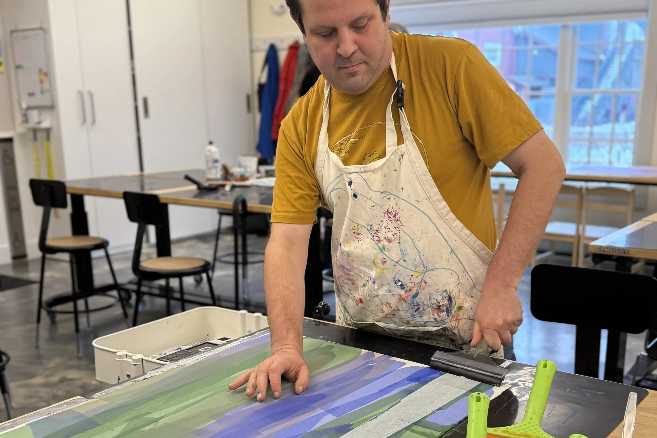 CATA artist Scott adds a stroke of white to a blue-green panel.