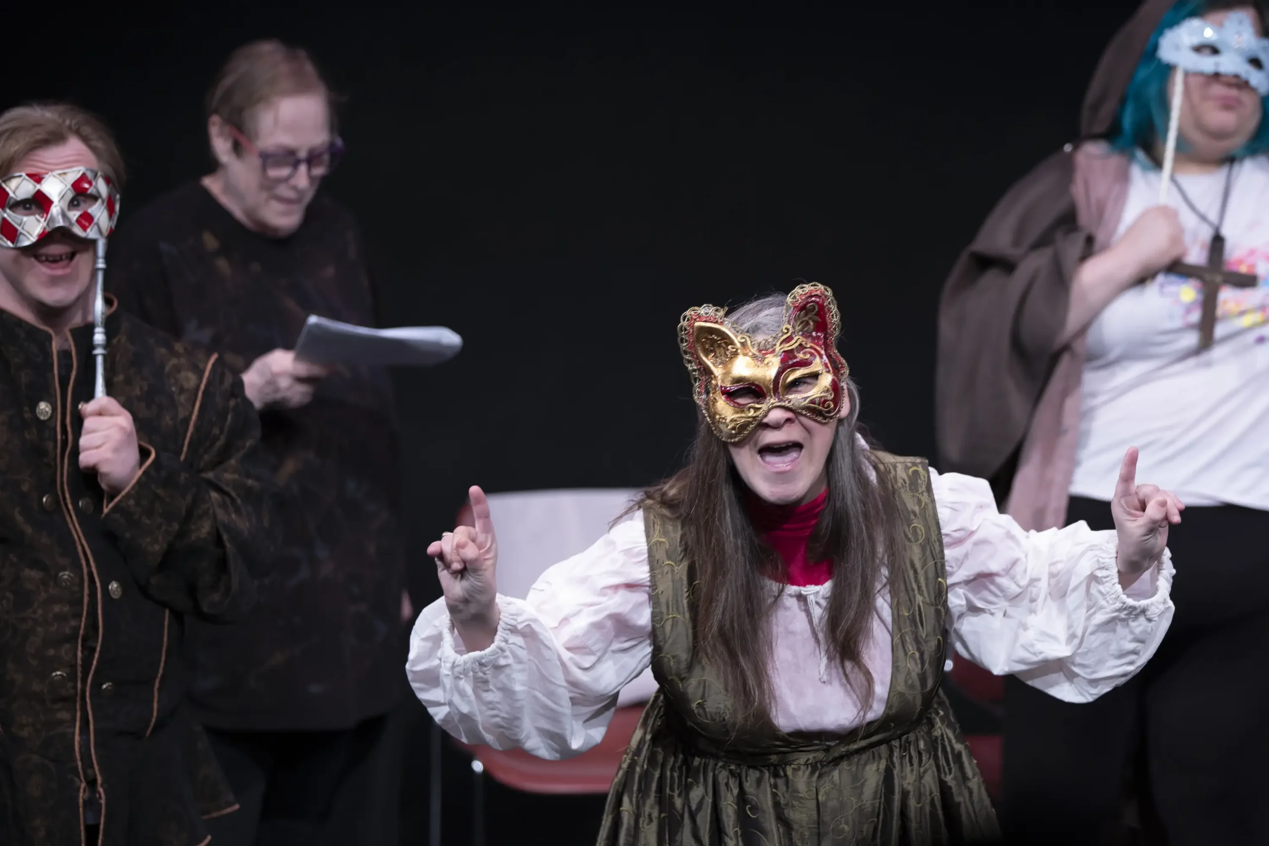 Dan, Kellie, and Sam don mysterious masks.