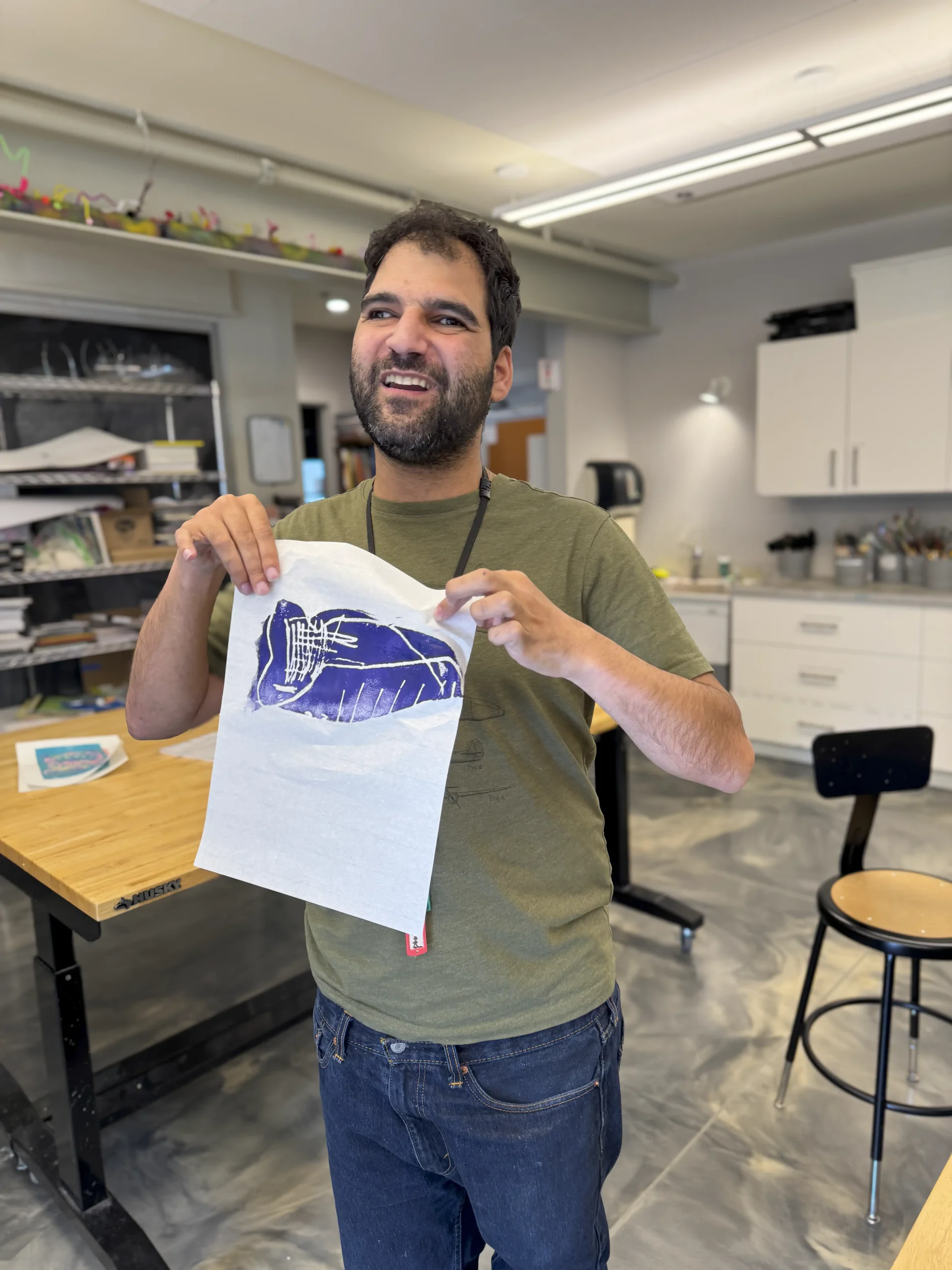 An artist holding up a blue print