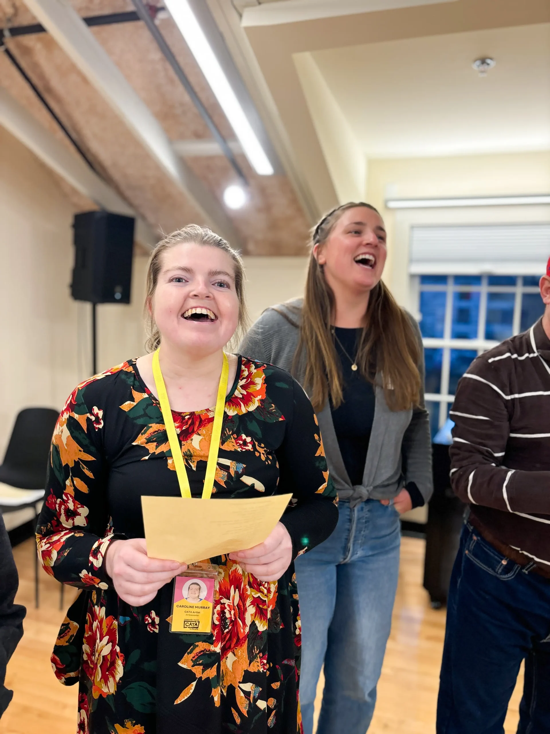 Two people singing in a bright room